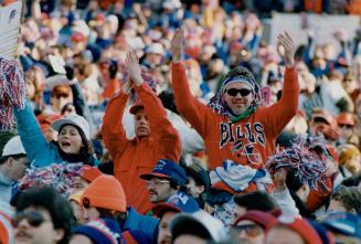 Bills boosters come in many shapes and sizes and under varying layers of clothing (at top), to cheer on quarterback Jim Kelly (above, taking a snap fr(...)