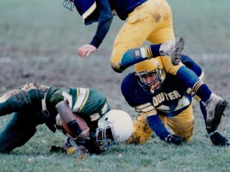 Gridiron Tangle. Football players from Paul Dwyer HIgh School (In blue) and Pickering High (in green) grappie during a game last Friday. Dwyer won 28-(...)