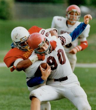 Few Rivals: A Victoria Park Panther, from North York, tackles Andre Salvi, of Toronto's Humerside Huskies, in a dwindling league made up of three school boards