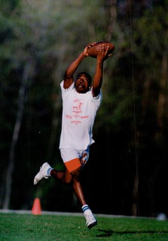 Got it: One of a number of hopefuls looking to catch the interest of scouts at a football camp last week