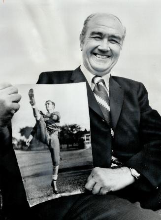 Glory Days: Ab Box, punting star of Argos' 1933 Grey Cup victory, remembers those bygone days as he displays a long ago photograph of himself in action