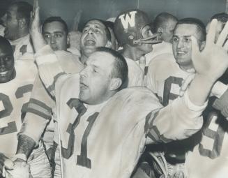 Winners. The physically battered but determined Bombers celebrate their victory in dressing room. Half back Ron Latourelle (31) leads cheering. Latour(...)