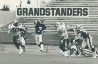 In the air: Argo quarterback Condredge Holloway fires a pass in last night's game, as Concordes' Steve Raquet rushes out to try for it, trailed by Argo Jeff Inglis