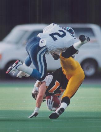 Lowering the boom: Argo cornerback Reggle Pleasant levels Hamilton receiver Wally Zatyiny during Toronto's 39-34 victory over the Ticats at Ivor Wynne