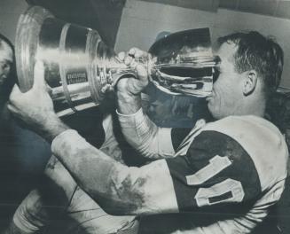 Victorious quarterback Bernie Faloney drinks deep from the Grey Cup