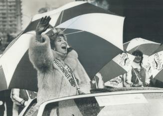 Let it rain, who cares? askes Miss Argonaut Debbie Spring as she waves to the crowds along the drenched Grey Cup Parade route in downtown Vancouver ye(...)