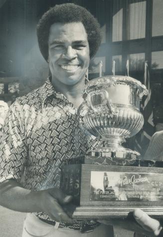 Rafe Botts of Los Angeles holds Peter Jackson Trophy, emblematic of the Ontario Open golf championship, after he shot 71 yesterday for 3-stroke victory,