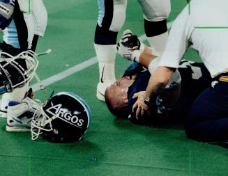 His season's over: Argonauts middle linebacker Chris Gaines gets treatment on the sidelines for torn ligaments that brought his season to a quick end