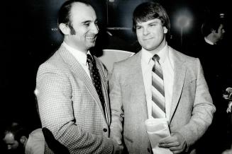 Shake on it: Argonauts' head coach Bob O'Billovich, left, welcomes Mike Kirkley of the University of Western Ontario after the Argos had made him their top draft pick in CFL annual draft