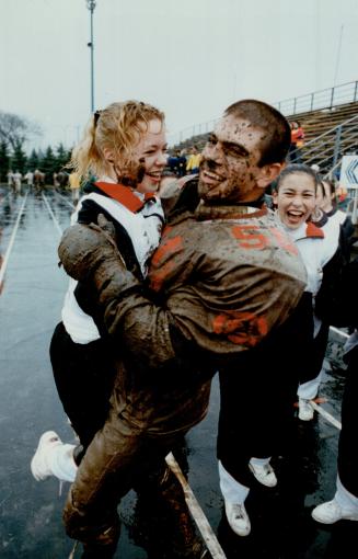 His name is mud. Actually, it's Magnifico, as in John Magnifico of St. Thomas Aquinas, who's congratulated by cheerleader Kim Allan after his squad up(...)