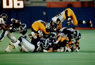 Stopped cold: Ticats stuffed this Argo rushing attempt but the Boatmen managed 533 yards of offence in last night's game