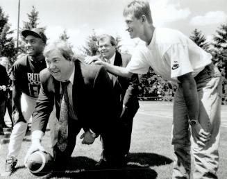 Team McNall: The opening of the Argo camp had a loft of showbiz to it, with John Candy snapping the ball to Bruce McNall, while Wayne Gretzky, right, and Rocket Ismail strike intimidating poses
