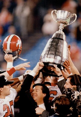 Calgary Stampeders' quarterback Doug Flutie, left, and club owner Larry Ryckman celebrate last night's win