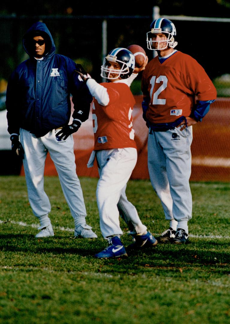 Target practice: Argo quarterbacks Rickey Foggle, left, and Mike Kerrigan, right, watch John Congemi throw bombs yesterday