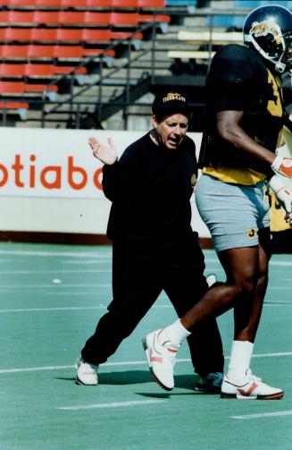 A Holler Guy. New Ticats coach David Beckman, shown with linebacker Dan Sellers, is described as a holler guy