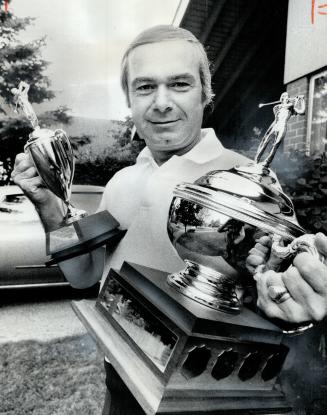 The winner of the Scarborough staff golf tournament, Frank Faubert, holds his trophies - trophies that were donated and presented by Joe Lebovic, the (...)