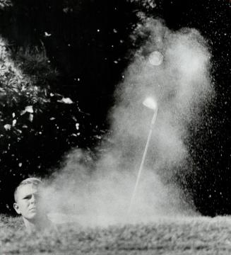 Coming out of the sahara. Almost below horizon in deep sand trap on 17th hole at Toronto Golf Club, Islington's Dan Gordon makes explosion shot work d(...)