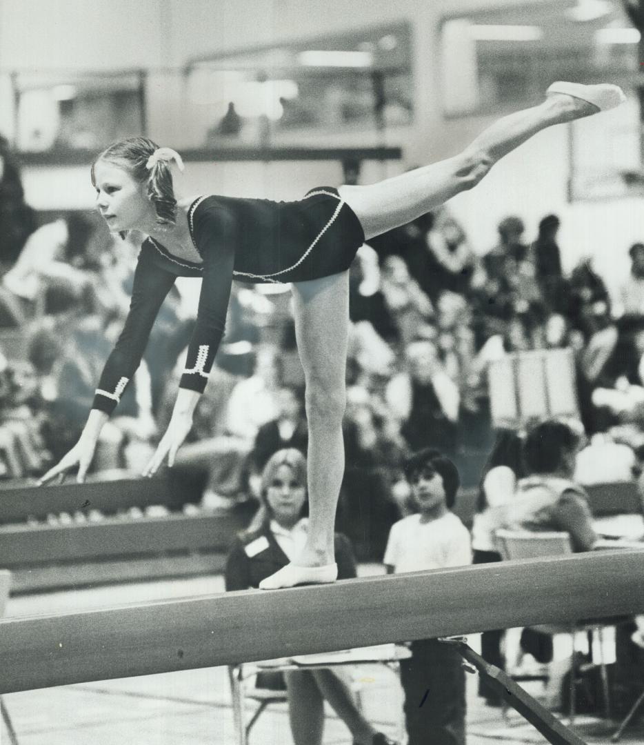 Striking a pose on balance beam, 11-year-old Roberta Farmer of Selwyn School competes in Metro East regional gymnastics finals at Seneca College yeste(...)
