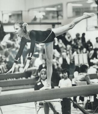 Striking a pose on balance beam, 11-year-old Roberta Farmer of Selwyn School competes in Metro East regional gymnastics finals at Seneca College yeste(...)
