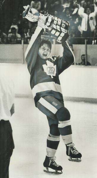 Two out of three, Marlboro captain Bruce Boudreau skates around Kitchener rink holding Memorial Cup after Marlies won junior hockey title for second time in three years