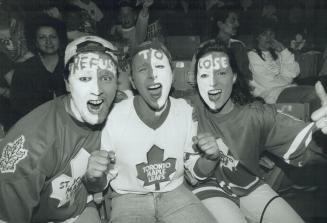 Color commentary: Maple Leaf fans Todd Murphy, Alfredo Iuele and Susan Atkinson show off their Refuse To Lose look as they watch the game on the JumboTron at SkyDome last night