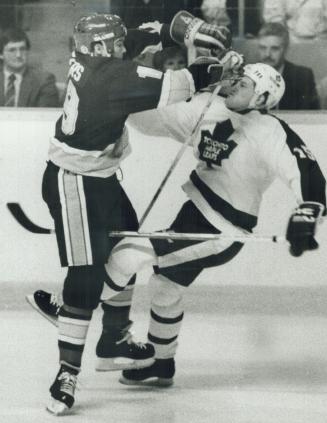 Pow! St. Louis Blues' leftwinger Eddy Beers gives a two-fisted shot to Maple Leafs' defenceman Bob McGill in a set-to during last night's third game b(...)