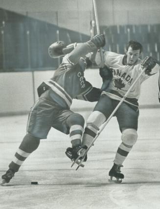 Hat check at the Gardens, Helmet flying, Russia's Alexander Marynuk, of Moscow Selects, gives hard body check to Terry Caffery, of Canada's Nationals,(...)