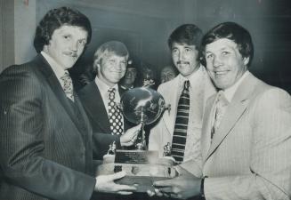 Admiring Charlie Conacher Memorial Trophy awarded to New York Rangers' Ted Irvine (far left) are hockey stars (left to right) Bobby Huil, Phil Roberto(...)