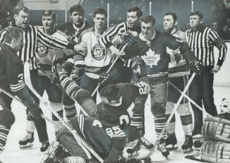 This is hockey?, Referee Vern Buffey (right rear) doesn't seem to think much of the action and other players are only mildly interested as they watch (...)