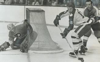 A peak around the post is taken by Philadelphia goaltender Doug Favell during Saturday night's National Hockey League game against Toronto Leafs. What(...)