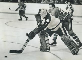 Who have we here?, Frank Mahovlich of Montreal Canadiens must have been surprised when he found a puck-carrying Jacques Plante stick-handling past him(...)