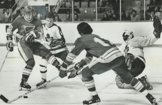 Hot Goalmouth Action: St. Louis Blues' Floyd Thomson (18) is kept in check by firmly planted stick of Leafs' Jim McKenny as Blues' Phil Roberto lunges(...)