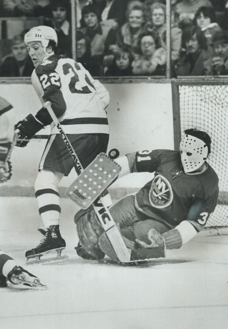 Goaltender Bill Smith (31) of New York Islanders just got his glove to this Maple Leaf shot during last night's 4-3 Toronto victory over Islanders at Gardens