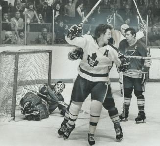 Joyful Moment for Leafs is pinpointed by Darryl Sittler who raises stick as he wheels away from fallen St