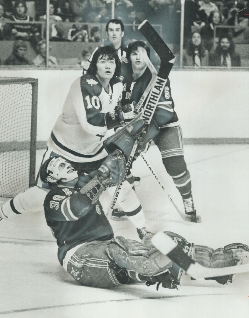 Where's The Puck? That's the obvious question New York Rangers' goalie Gilles Villemure, teammate Gilles Marotte (6) and Leafs' George Ferguson (10) a(...)