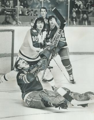 Where's The Puck? That's the obvious question New York Rangers' goalie Gilles Villemure, teammate Gilles Marotte (6) and Leafs' George Ferguson (10) a(...)