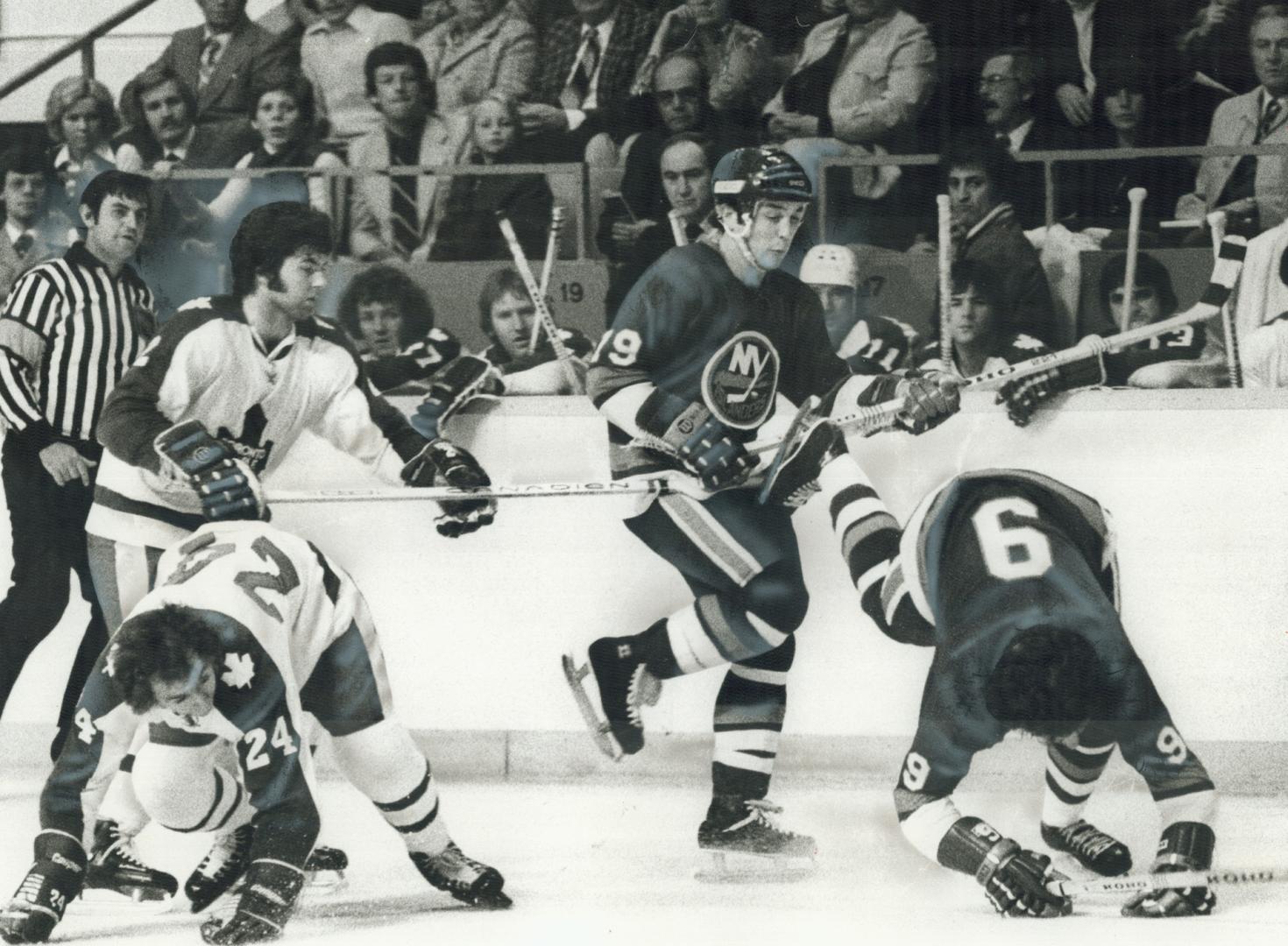 Over they go: Leaf players on the bench watch on-ice tumbles Saturday night at the Gardens