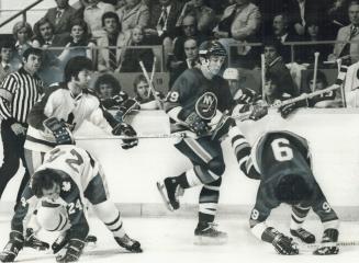 Over they go: Leaf players on the bench watch on-ice tumbles Saturday night at the Gardens