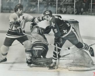 Out Of Harm's Way - Toros defenceman Jim Dorey (left) has decided Quebec Nordiques Rejean Houle can do little damage from the side of the net, so he w(...)