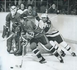 Away he goes . . . Canadiens' reje an houle (15) charges down the ice, Leafs' Inge Hammarstrom (11) is in hot pursuit but Leafs lost last night, 6-4