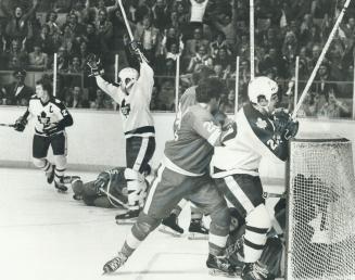 With Tiger Williams at crease, Lanny McDonald raises stick in joy after one of his three goals