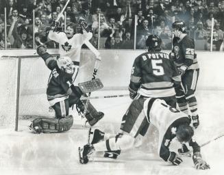 Agony And Ecstacy? Leafs and their fans celebrate Lanny McDonald's goal in first period, but Jack Valiquette (8) crumples to the ice after taking a hi(...)