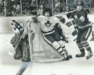 Sabres' Don Luce doesn't really have a stick impaled in his neck - Ian Turnbull's blade just creased him in action behind Leaf net