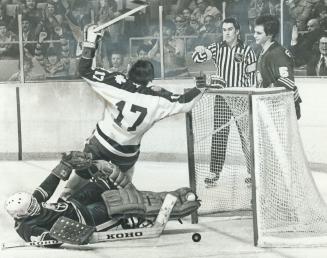 At Least This One Counted, Maple Leafs' Jerry Butler grabs net to keep from plunking down on to Buffalo Sabres' goaltender Don Edwards after scoring the opening goal in Leafs' 2-2 tie last night