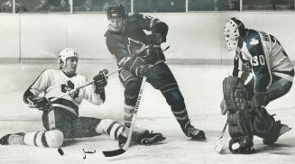 defenceman Borje Salming prevents the Colorado player from getting puck despite fact he's sitting on the ice