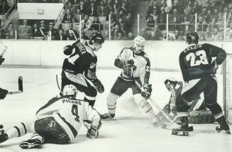 Not this time: Thomas Gradin of Canucks scored three goals against Leafs last night, but he missed on this opportunity when Toronto netminder Jim Rutherford smothered puck in the crease