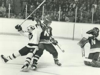Ice dancing, it isn't: North Stars' Mark Napier and Leafs' Greg Terrion battle each other for bouncing puck during second-period action near the Minnesota net in last night's game at the Gardens