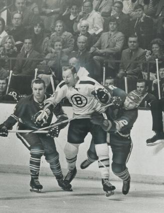 Ebullient Eddie Shack up to old tricks at Maple Leaf Gardens Saturday night, is completely off ice as he crashes between Leafs' Ron Ellis (left), Pier(...)