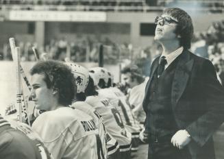 it couldn't be worse? Gilles Leger, who replaced Bobby Baun as coach of Toros, appears dismayed by action on ice at Maple Leaf Gardens as his World Ho(...)