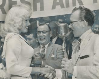 Jayne Mansfield shakes hands with TV singer Billy O'Connor at tumultuous city hall welcome for the curvaceous star